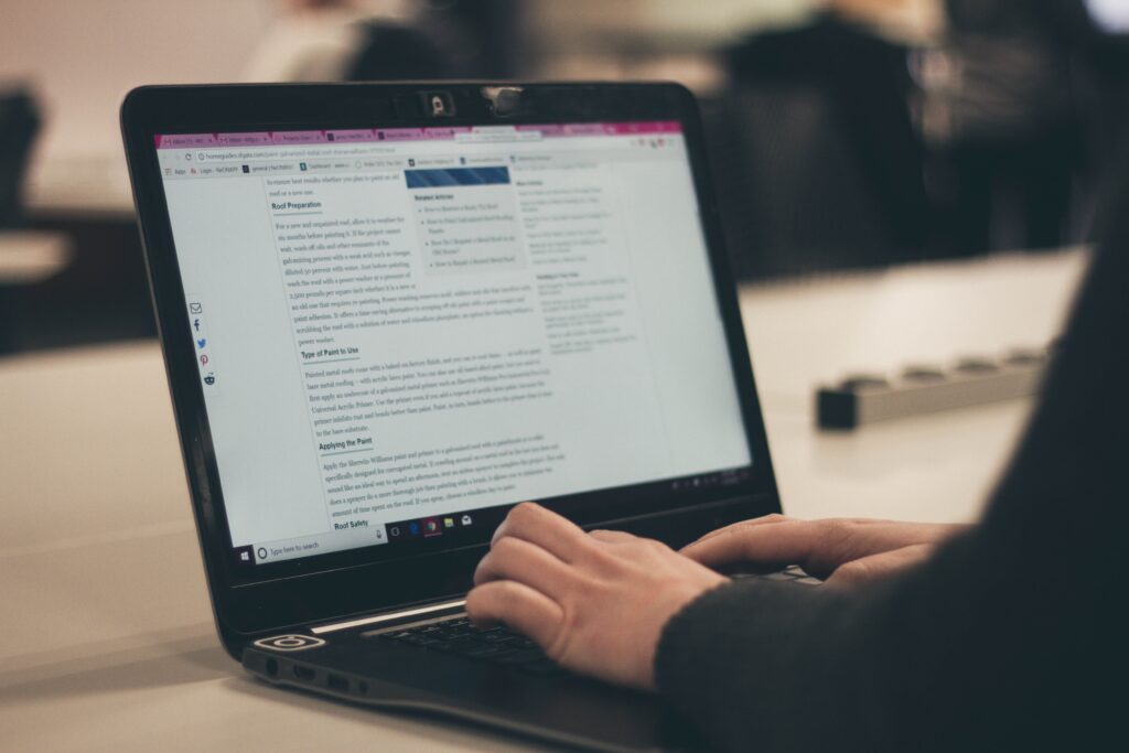 A person behind a computer displaying content